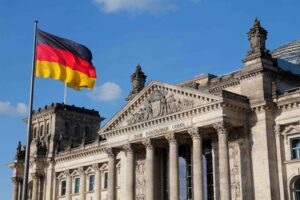 Historic Reichstag building with German flag fluttering in front